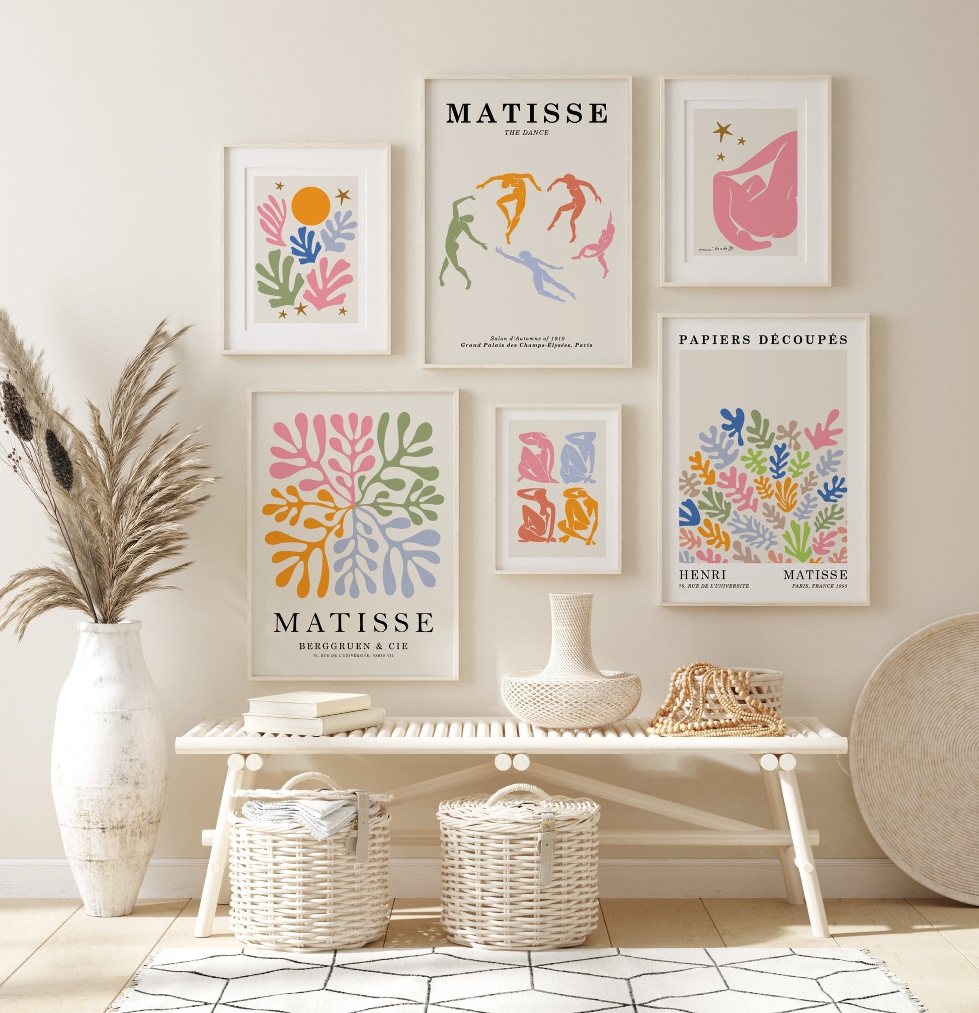 Colorful Henri Matisse prints hang on neutral walls in a room.